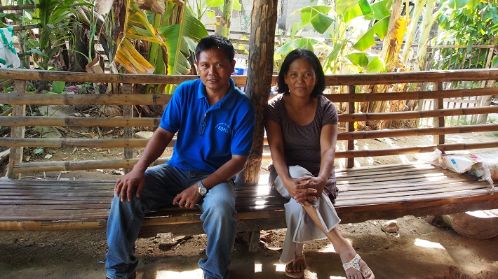 Antonia Quimson (right) is now able to grow rice in the saline parts of her farm using Salinas 11 that she obtained from municipal extension officer Lito Oroyan (left). (Photo by Paula Bianca Ferrer)